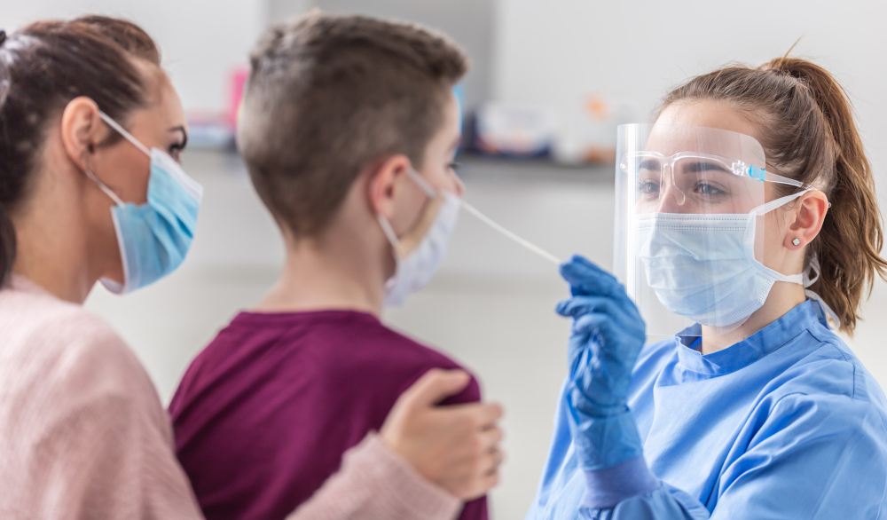 188 Healthcare worker in PPE administers a nasal swab test to a patient